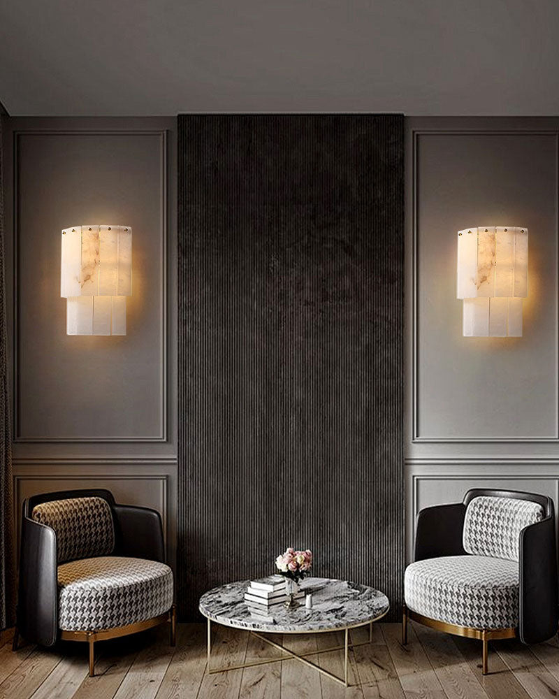 Elegant living room with marble wall sconces and chairs.