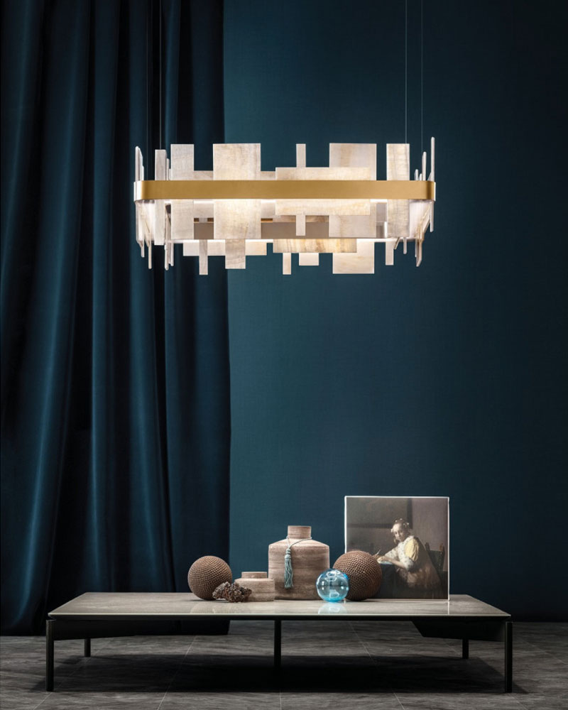 Marble slice chandelier above a modern coffee table in an elegant living room setup.