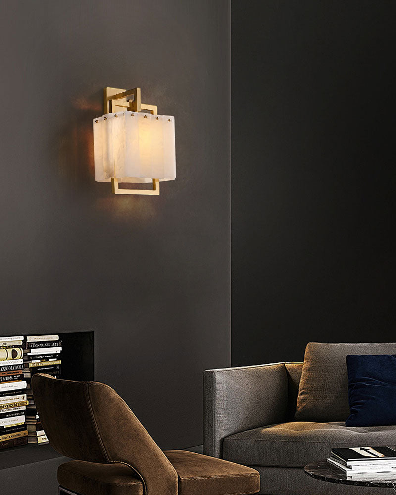 Gold and marble wall lamp enhancing modern living room ambiance.