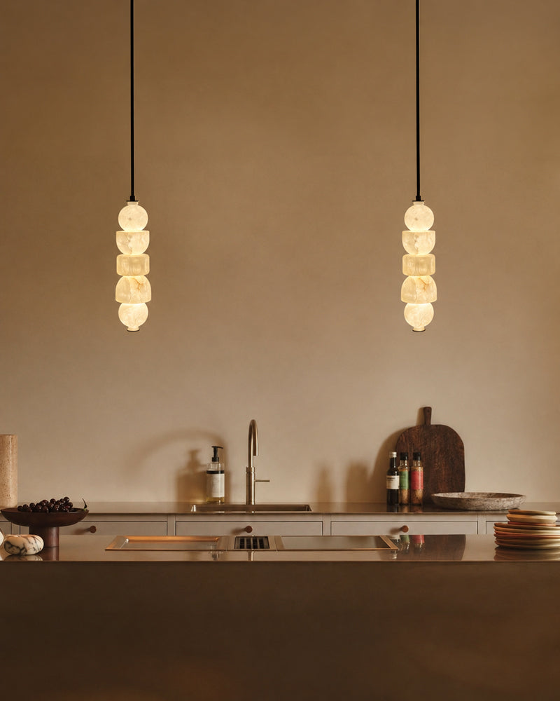 Globe pendant light with stacked alabaster-style glass shades on black suspension rods