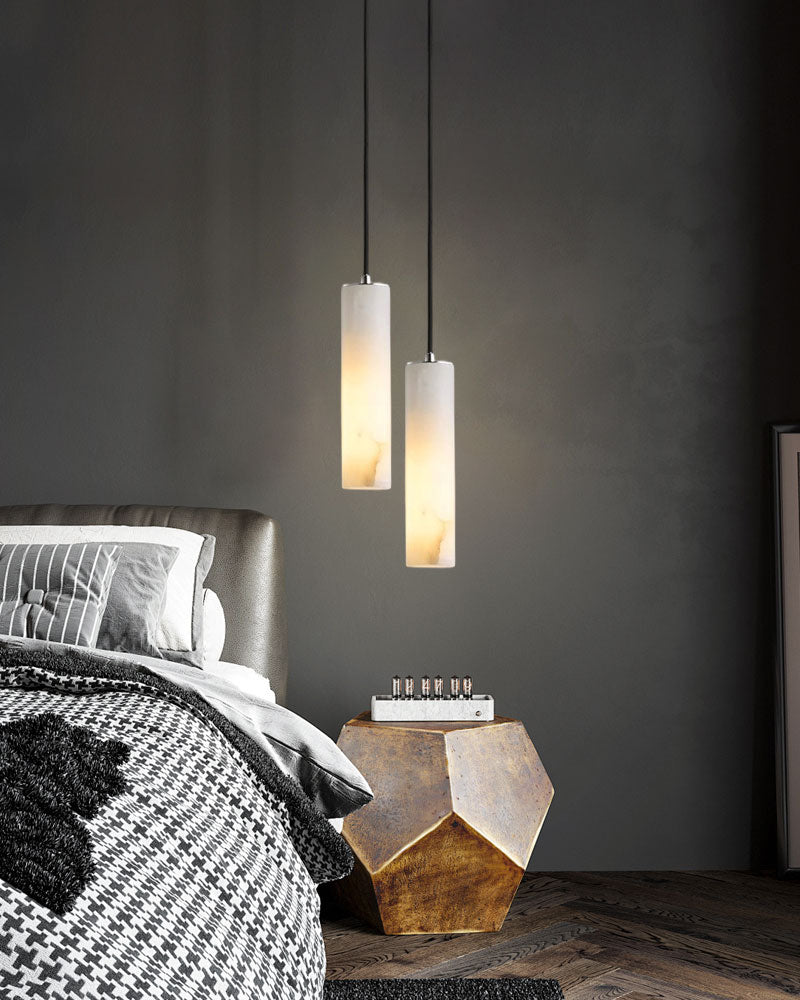 Stylish alabaster pendant lamps illuminating a cozy bedroom with a modern bed and decor.