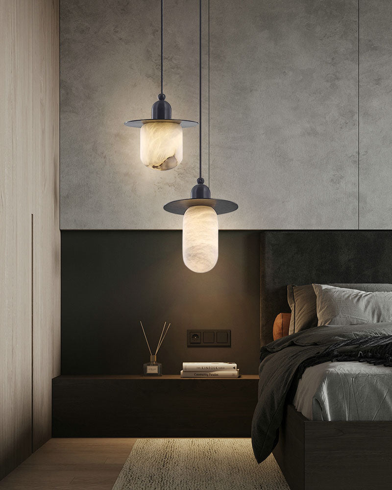 Alabaster pendant lamps in modern bedroom with black decor and nightstand.