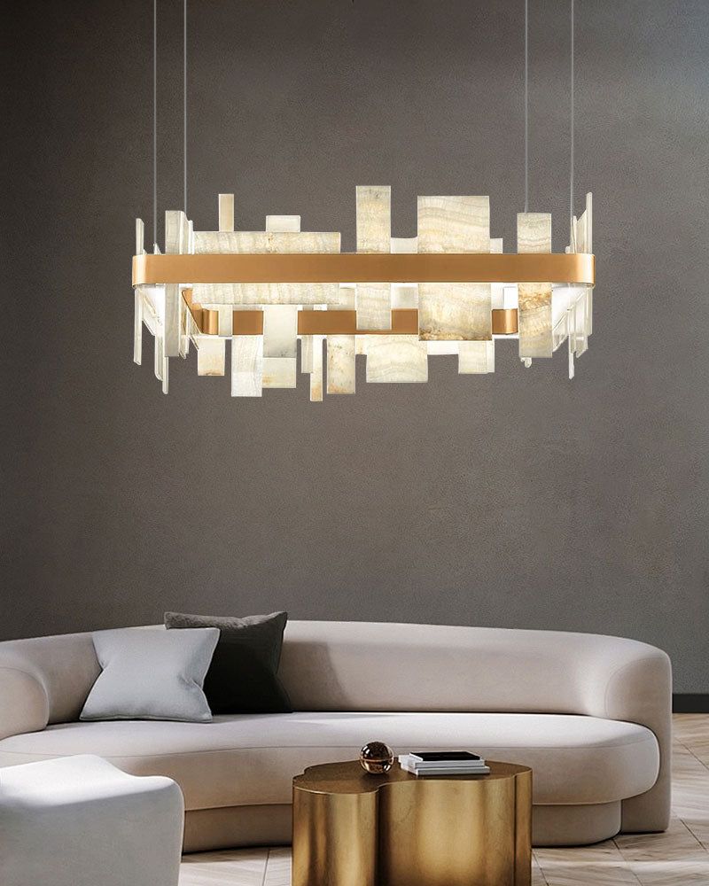 Elegant marble slice chandelier above a modern sofa in a chic living room.