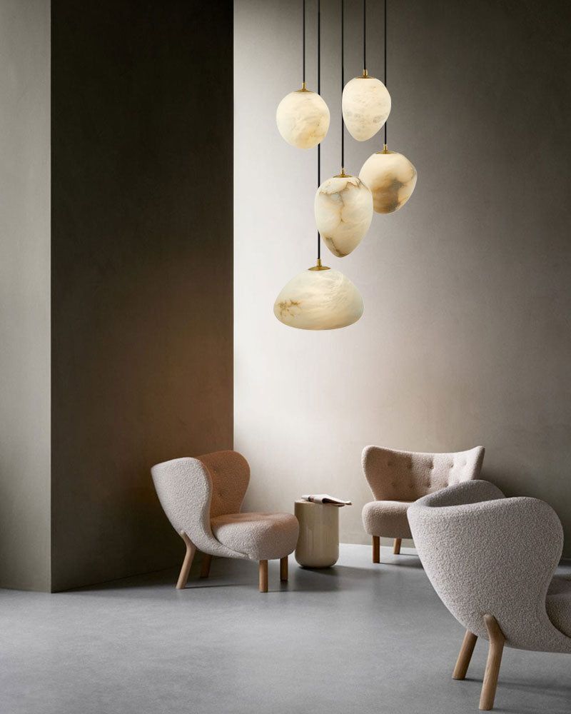 G9 Nature Alabaster Pebble pendant lights above cozy lounge seating.