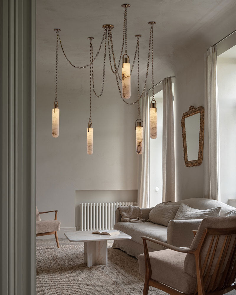 9-light brass LED cluster pendant lamp illuminating a cozy modern living room