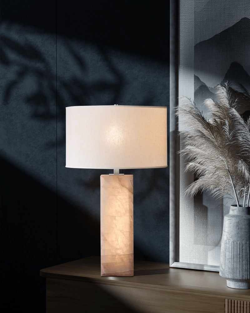 Alabaster marble table lamp with fabric shade placed on nightstand in modern decor