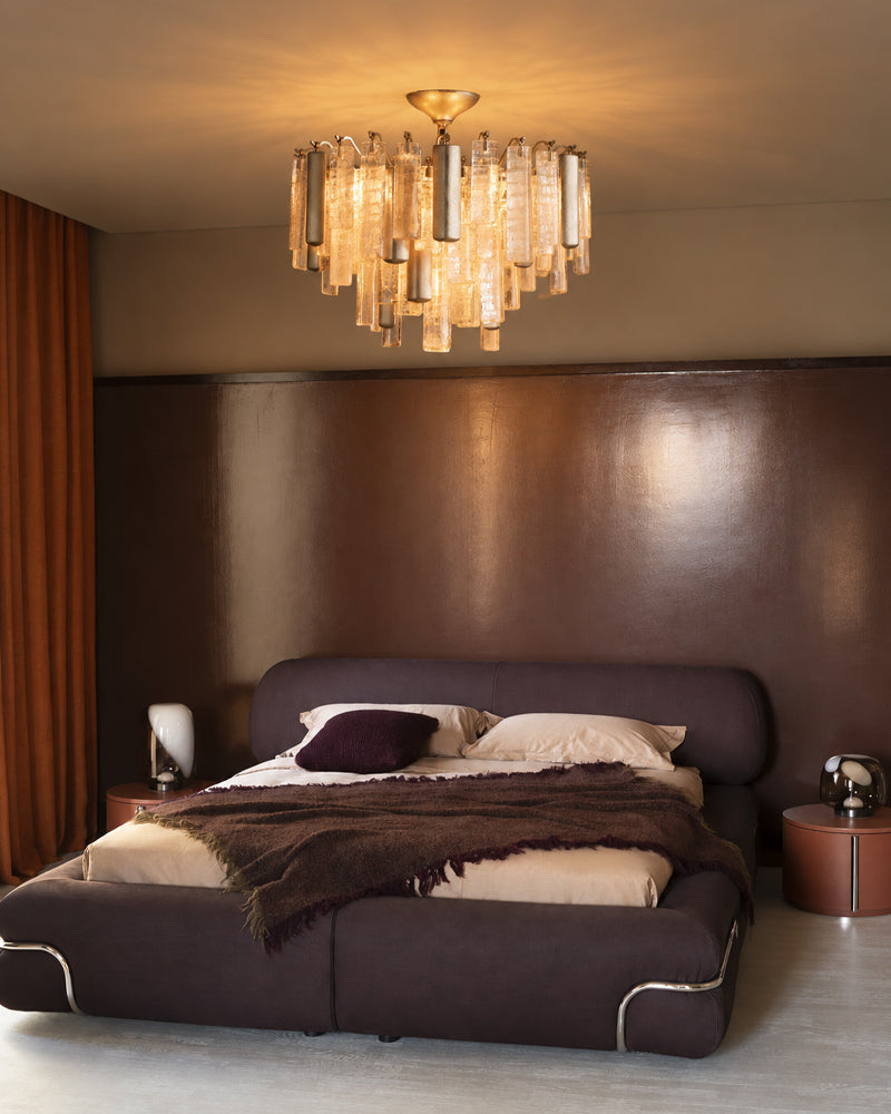 Brass multi-tier crystal flush mount ceiling light with warm glowing glass prisms