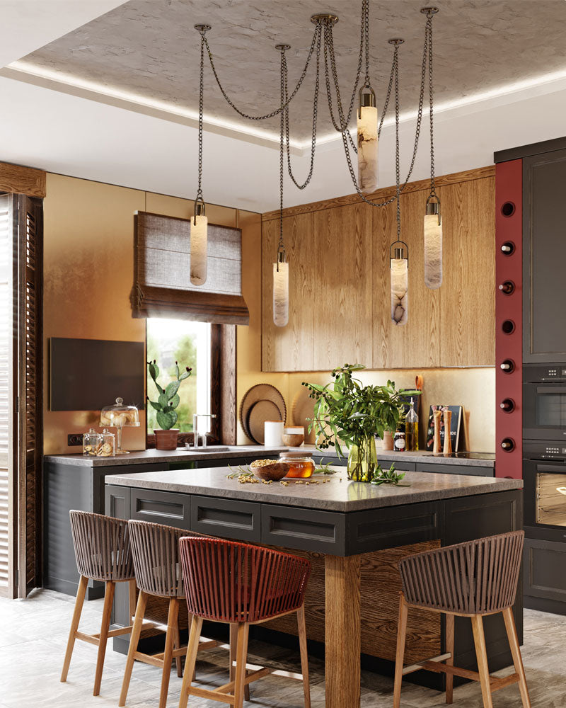 Brass LED cluster pendant lamp above a modern kitchen island with wooden stools.