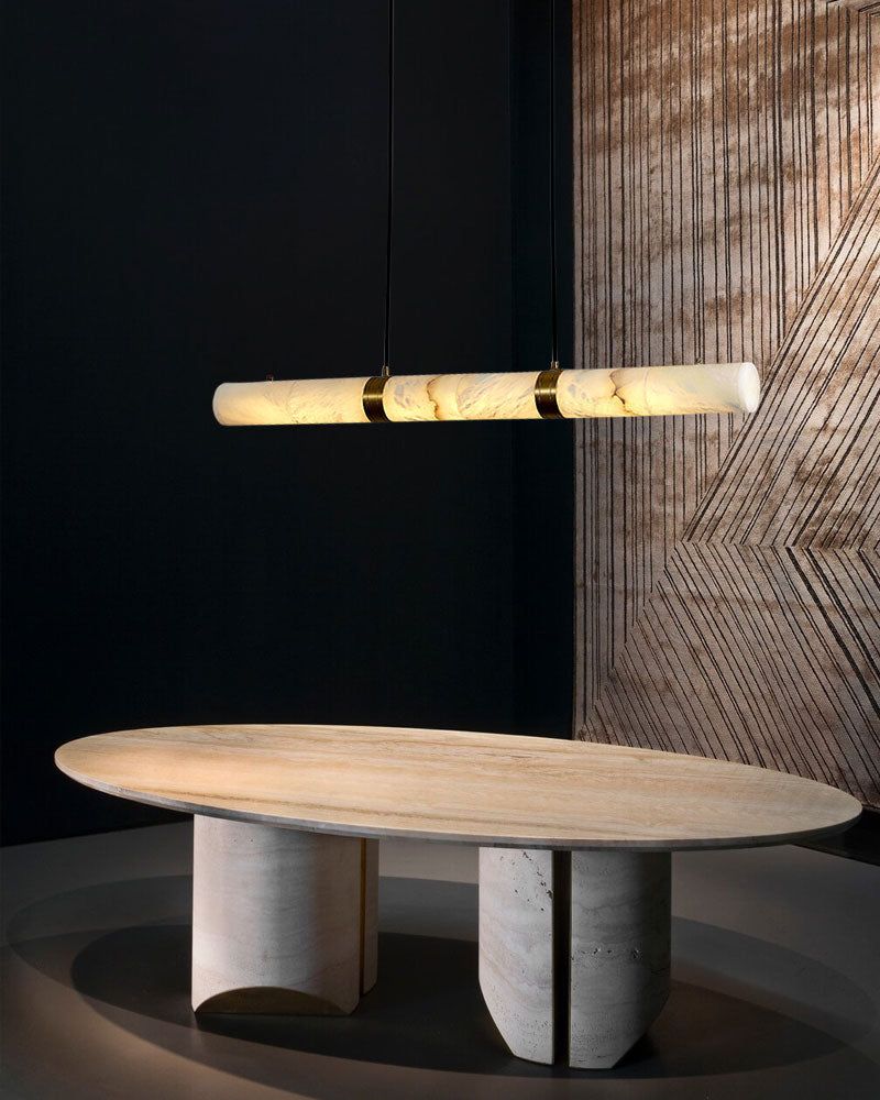 Elegant alabaster LED pendant lamp above a round marble dining table.