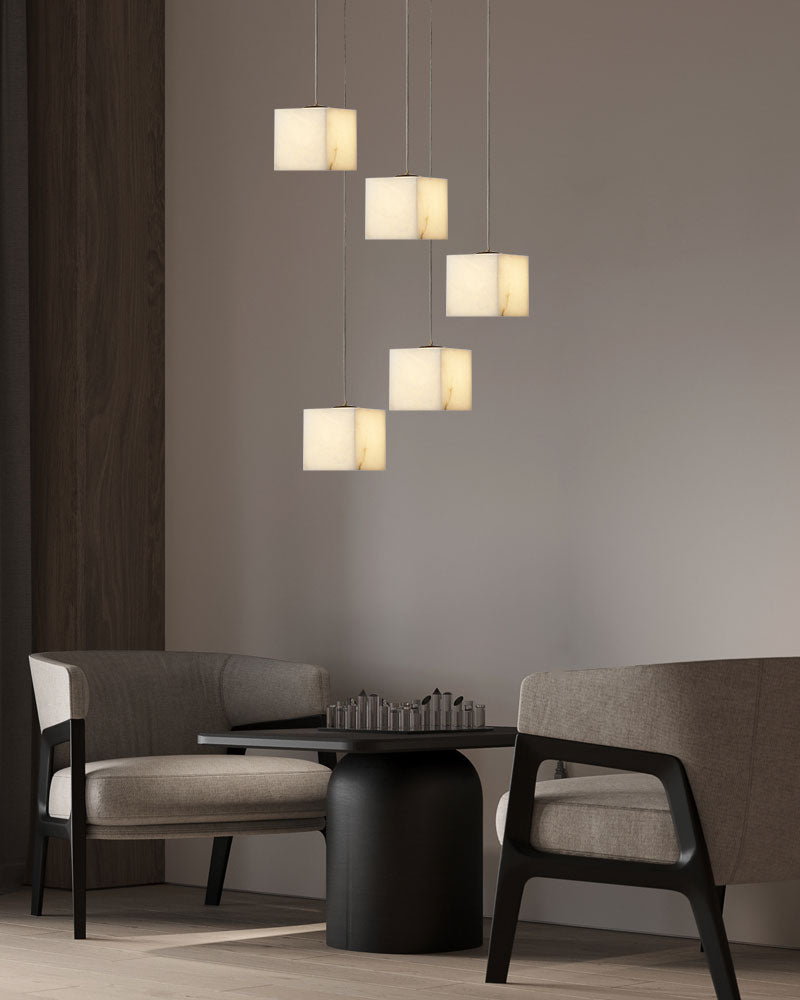 White alabaster square chandelier hanging over a modern chess table in a living room