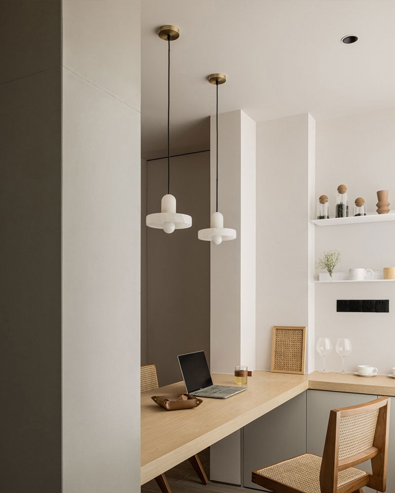 Stylish modern E27 alabaster pendant lights above a minimalist workspace with wood desk