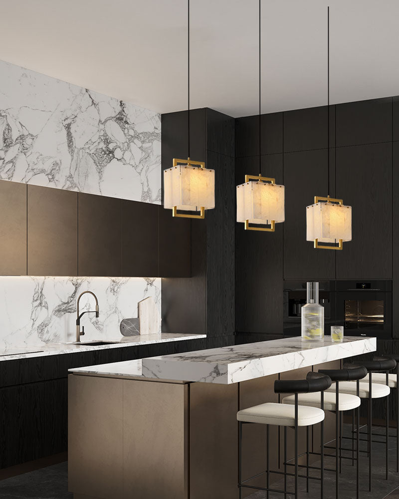 Elegant cluster pendant lights over a modern kitchen island with marble countertop.