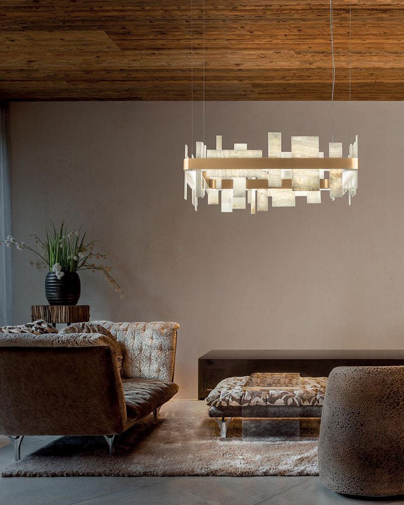 Marble and metal chandelier above a modern coffee table in a chic living room.