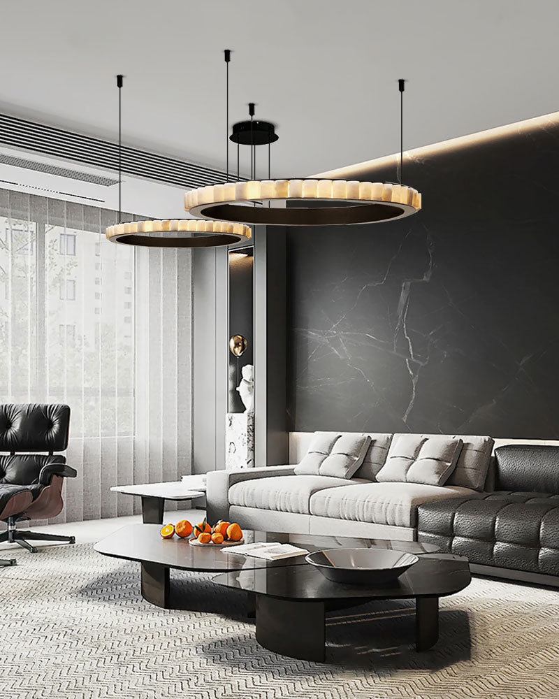 Stylish three-tiered round pendant lamp above contemporary living room furniture.