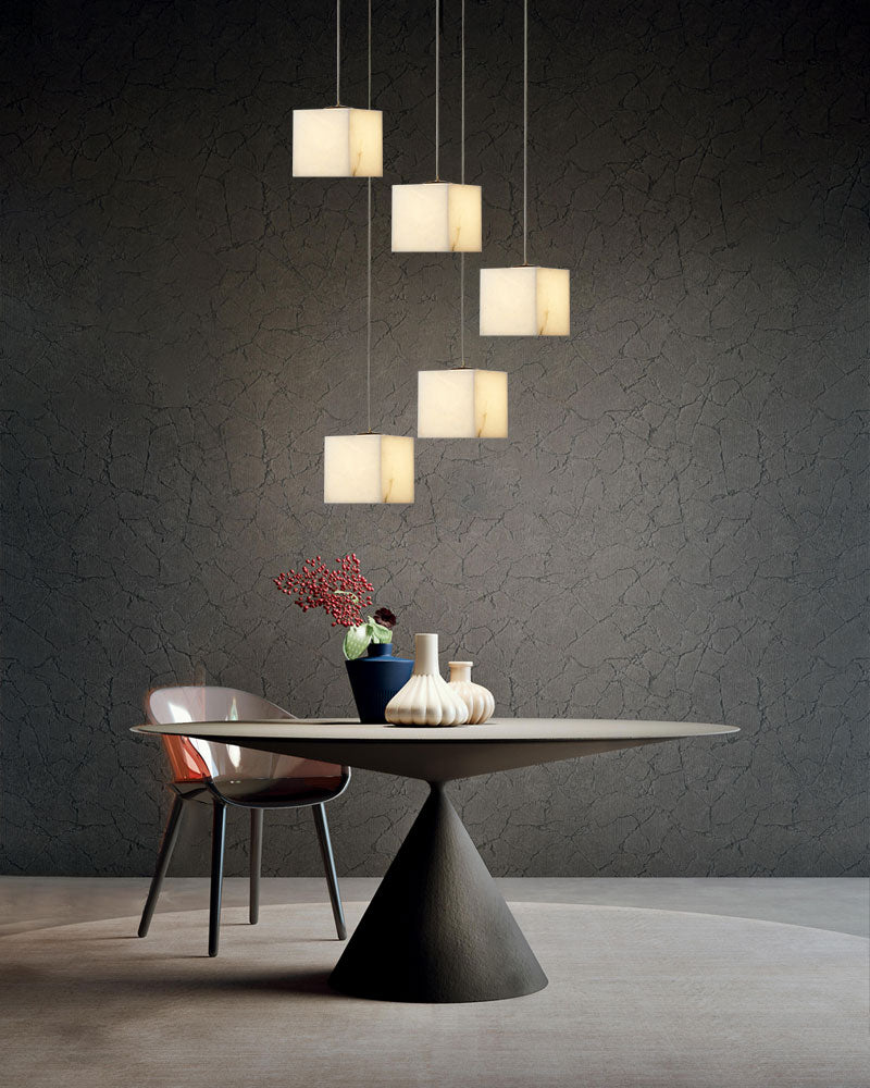 Stylish white alabaster pendant chandelier above modern dining table in contemporary setting.