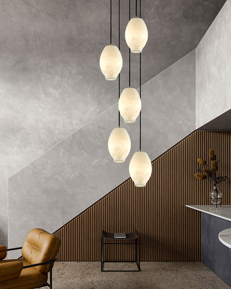 Five alabaster pendant lamps illuminating a chic modern living space