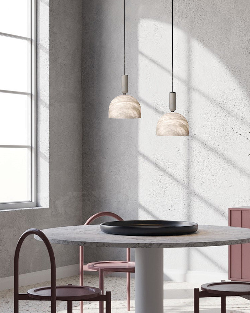 Postmodern LED white marble pendant lights above a round marble dining table in a modern kitchen.