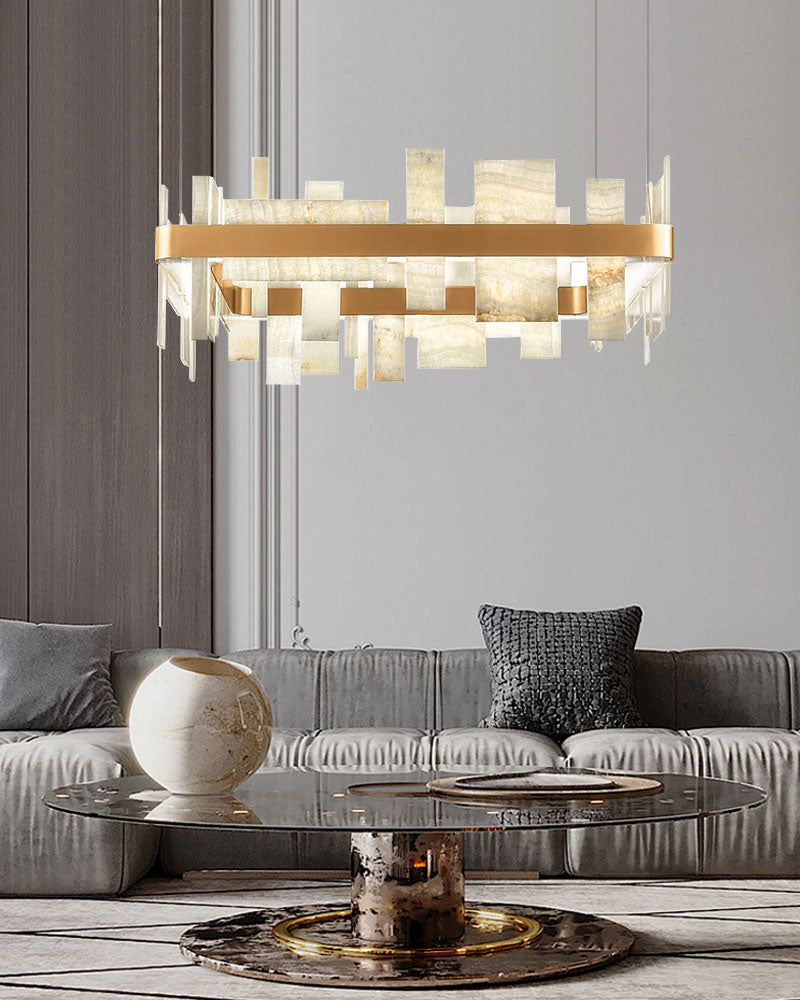 Marble slice chandelier above a glass coffee table in a modern living room.