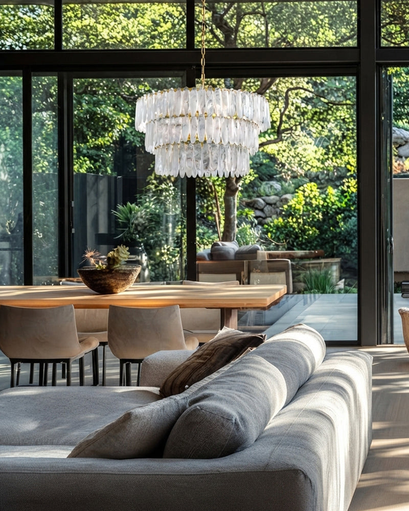 Multi-tiered clear glass chandelier with layered glass cylinders and brass chain