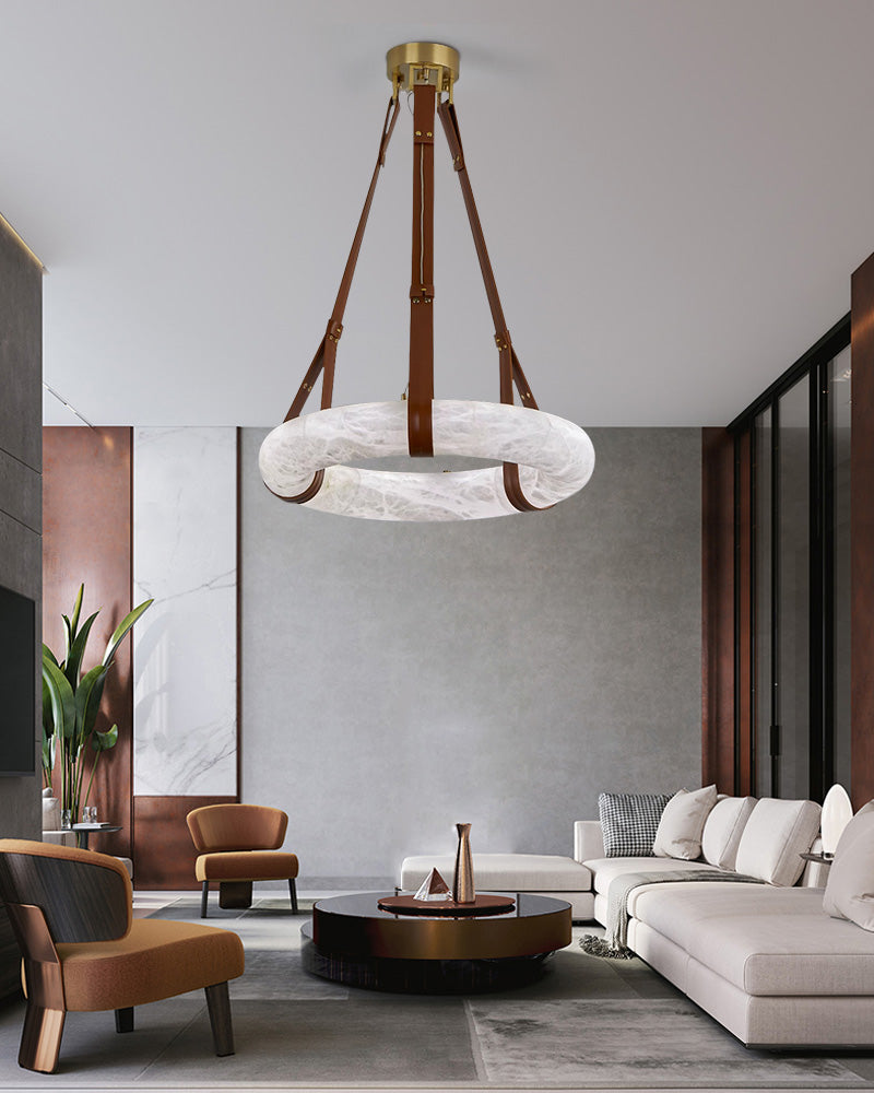 Stylish alabaster LED pendant lamp with leather straps above modern living room.