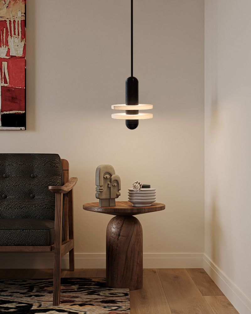 Modern pendant lamp over wooden side table with decor in stylish living room