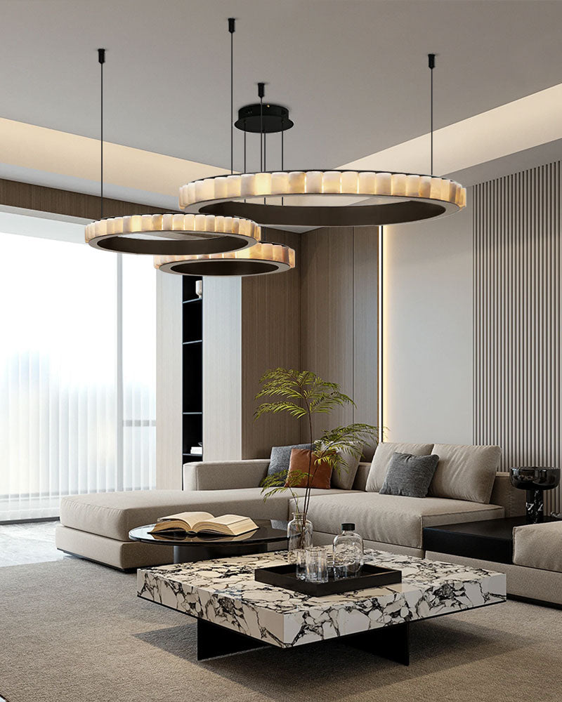 Three-tiered round pendant lamp enhancing modern living room with sleek coffee table.