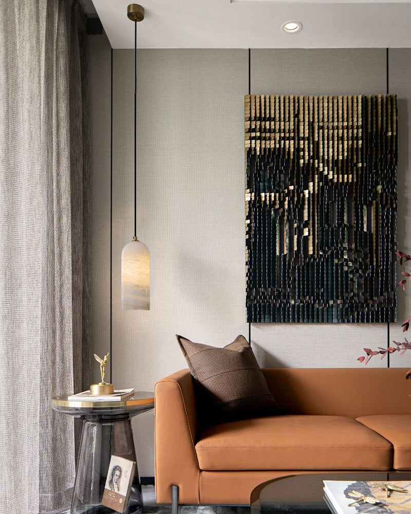 Modern living room with a brown sofa, marble side table, and elegant pendant lamp.