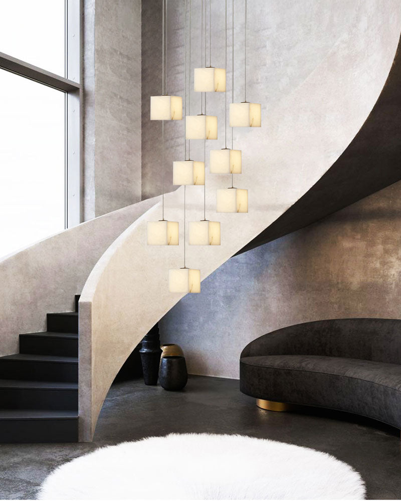 Contemporary white alabaster chandelier enhancing a chic living area with a spiral staircase.