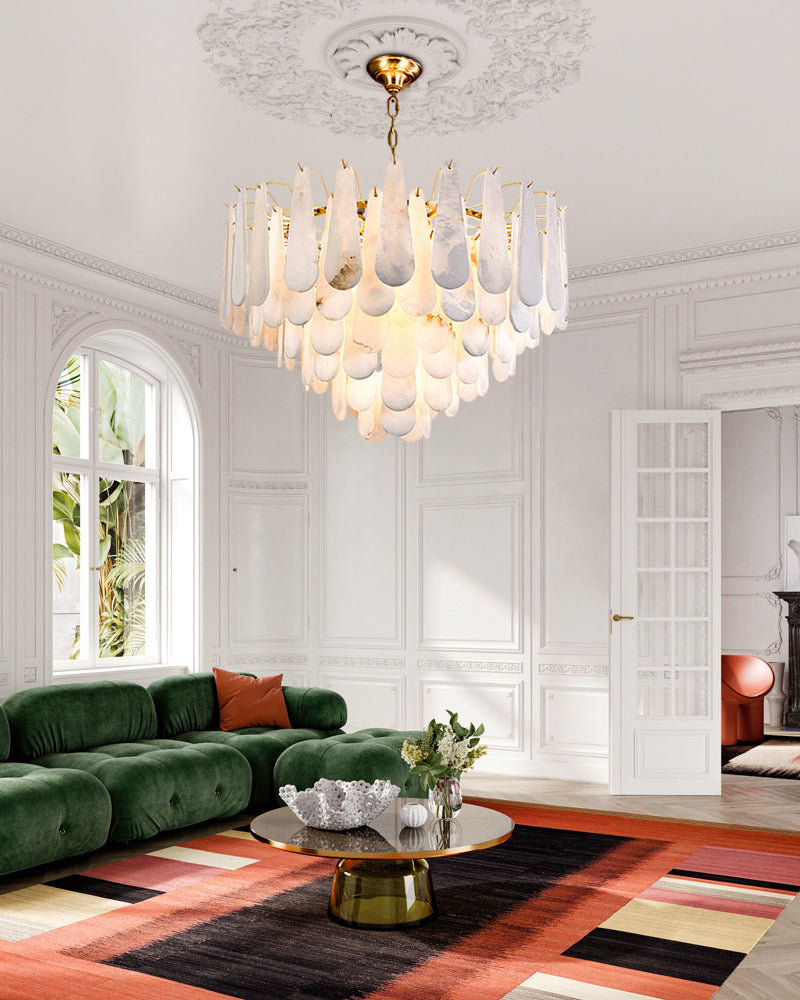 Elegant tiered raindrop chandelier in chic living room with green sofa.