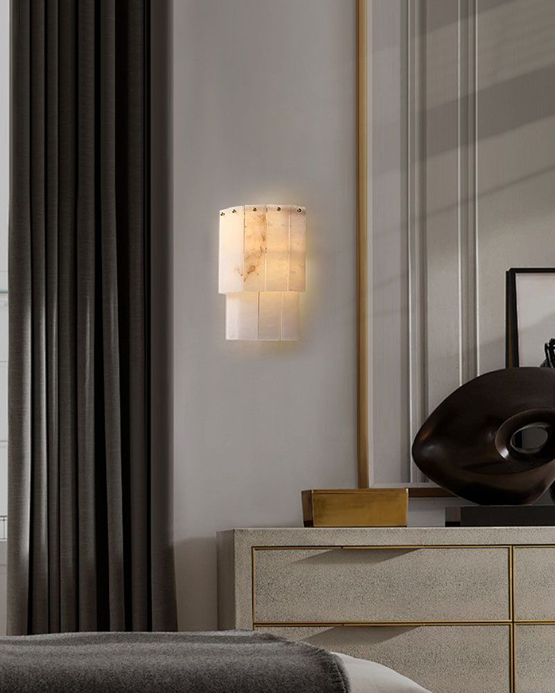 7-layer alabaster wall lamp illuminating modern bedroom decor beside a beige cabinet