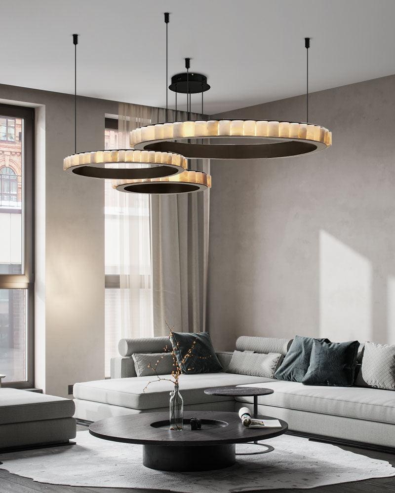 Three-tiered round ceiling pendant lamp illuminating modern living room decor