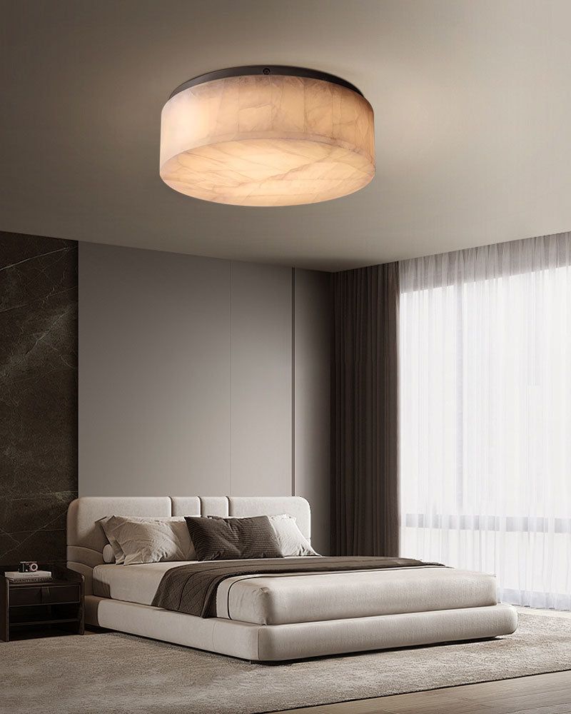 Warm alabaster round ceiling light in modern bedroom with neutral decor.