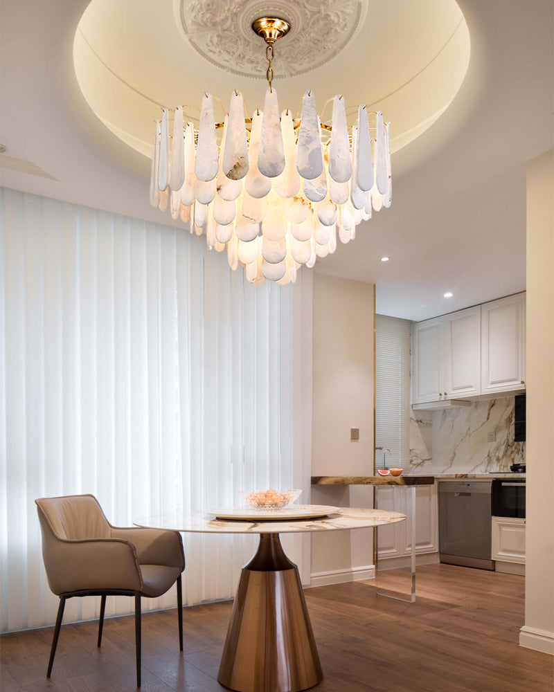 Tiered raindrop chandelier in modern dining area with metallic table