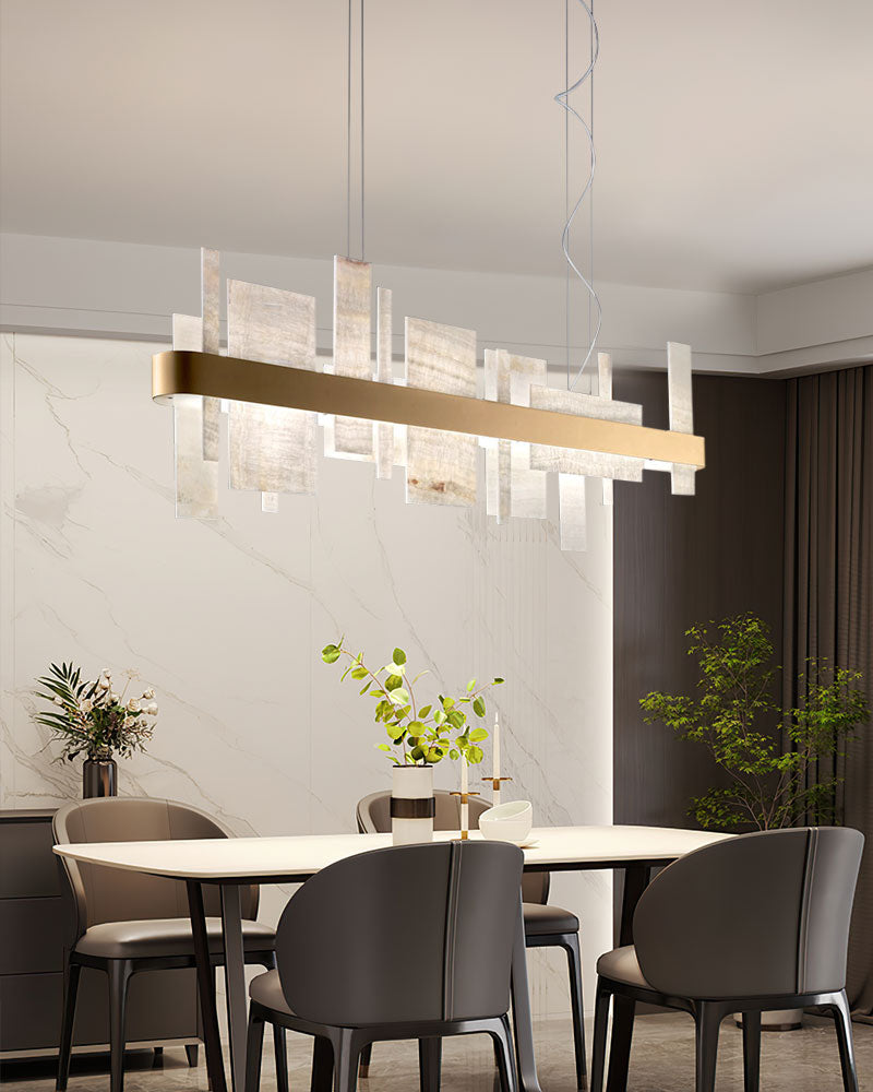 Marble slice chandelier above a stylish dining table in a modern kitchen.