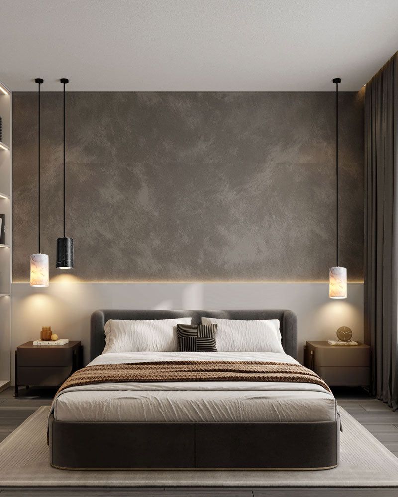Stylish bedroom with gray wall and cylinder pendant lamps above a contemporary bed