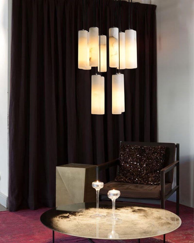 Stylish cluster of alabaster pendant lamps above a modern side table and chair.