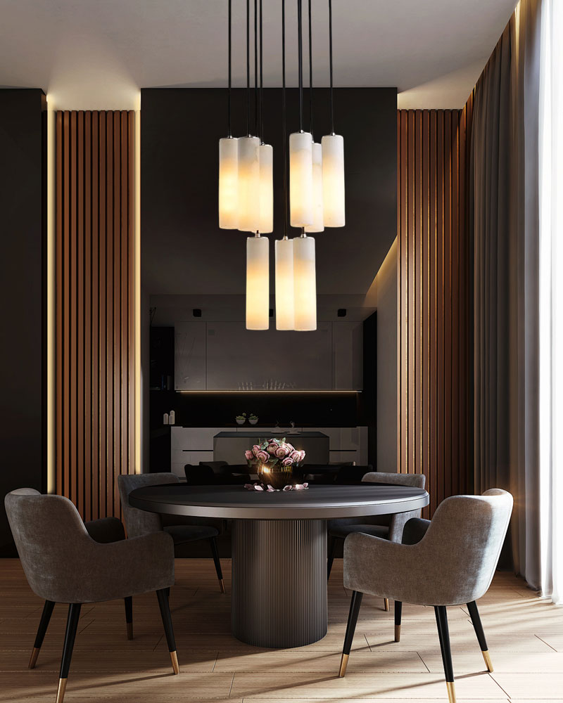 Four alabaster pendant lamps over a round black dining table in a modern dining room.