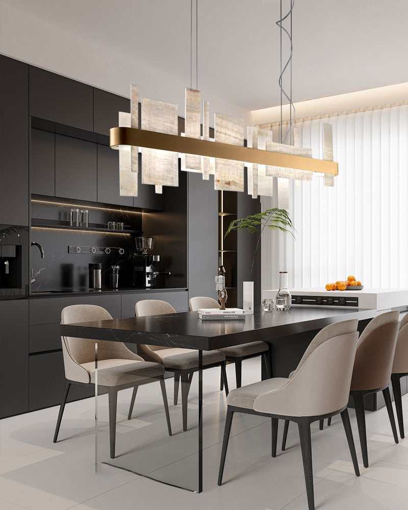 Luxury marble slice chandelier illuminating a modern dining area with sleek black decor.