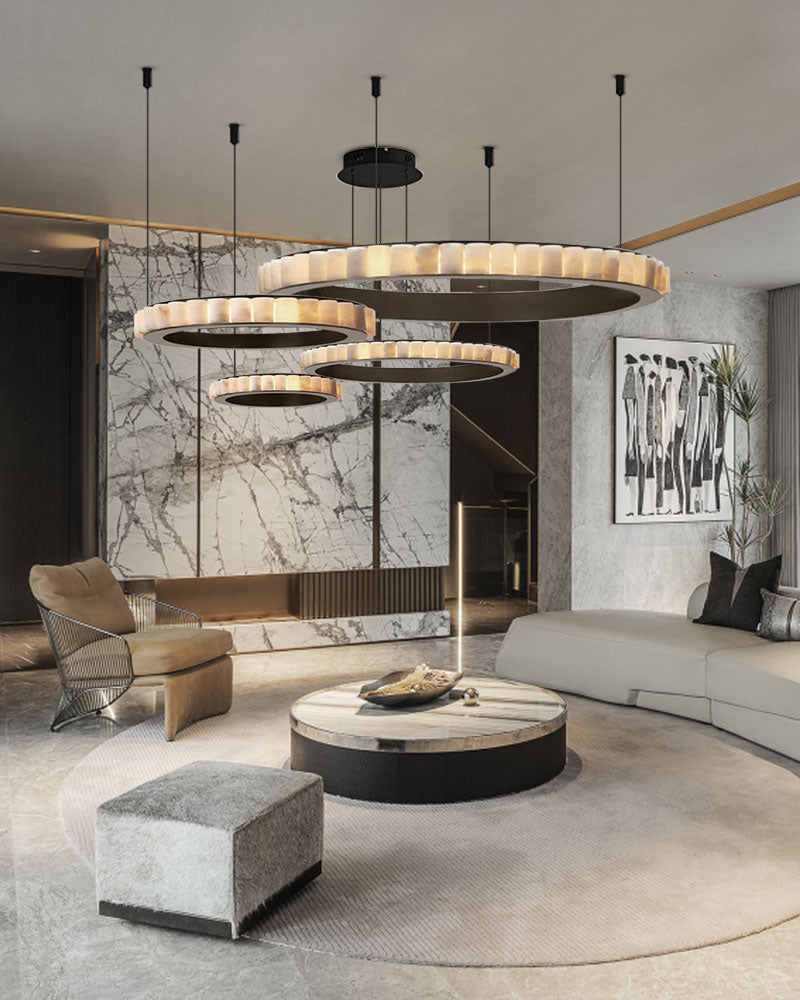 Three-tiered alabaster ceiling pendant lamp over modern living room with sectional sofa.