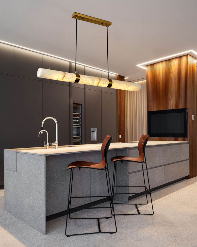 Alabaster LED pendant lamp above a modern kitchen island with bar stools.