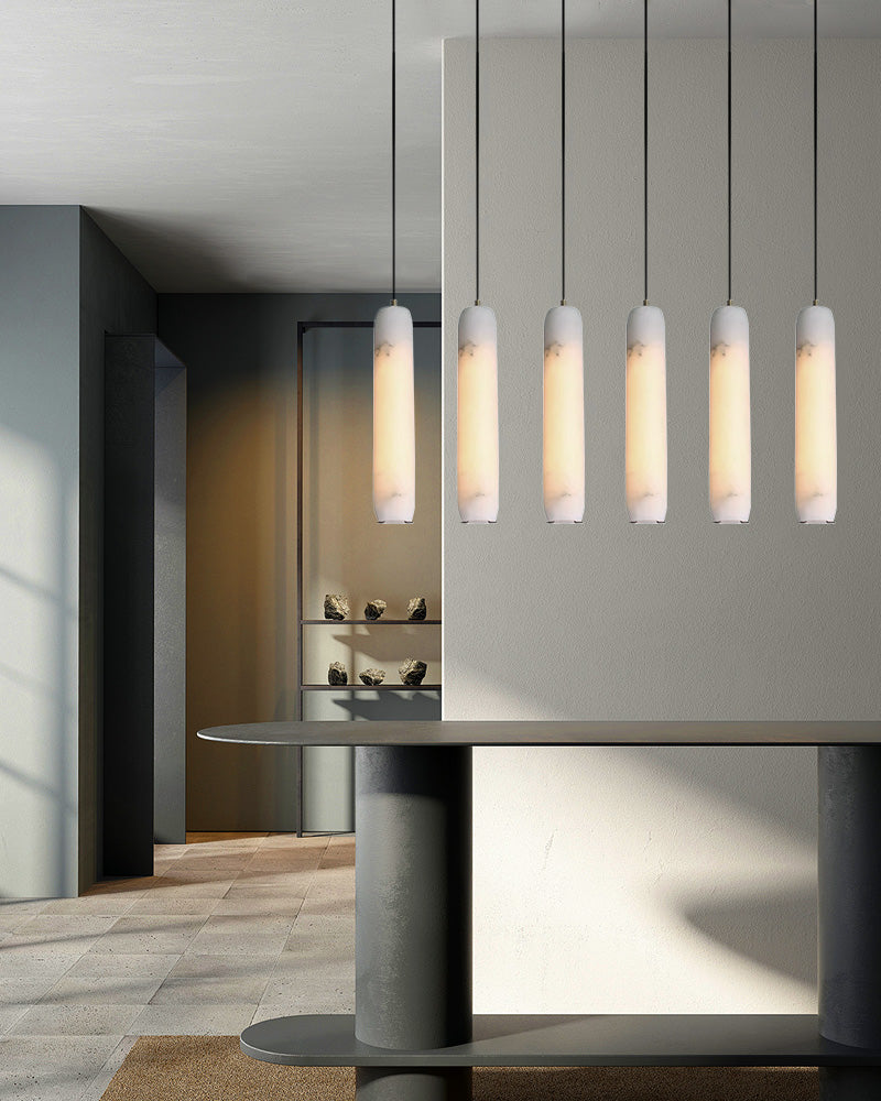 A series of pendant lamps with a cylindrical body in white marble