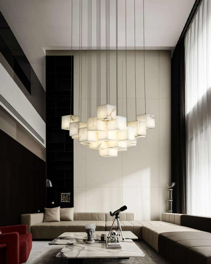 Stylish square white alabaster chandelier over modern coffee table in chic living room.