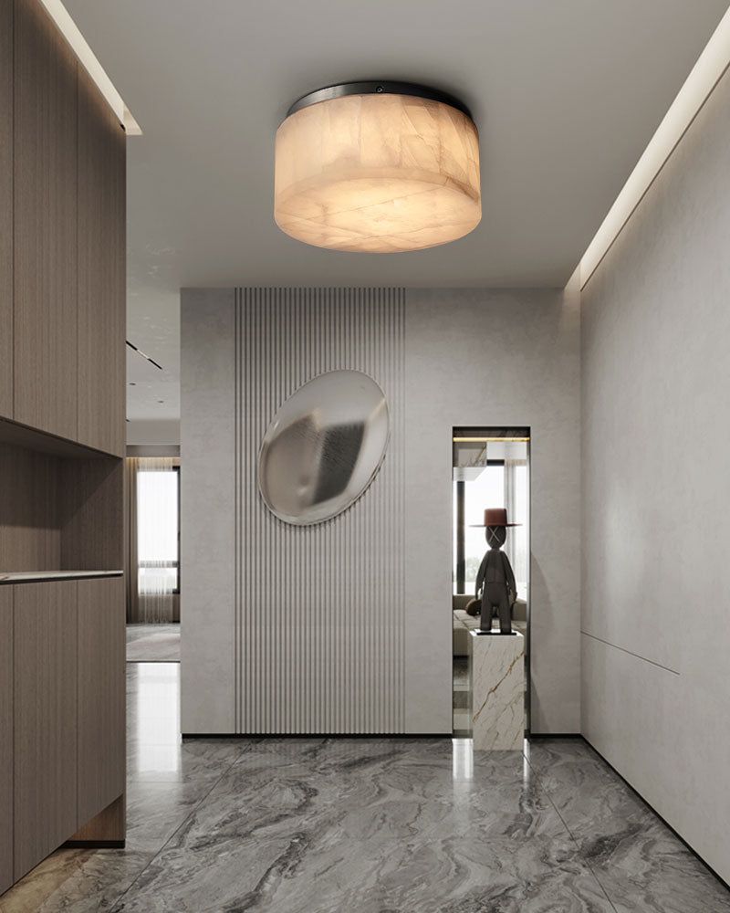 Round alabaster ceiling light in elegant modern hallway with sleek design.