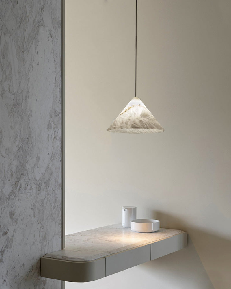 Modern alabaster pendant light with conical shade over minimalist kitchen counter