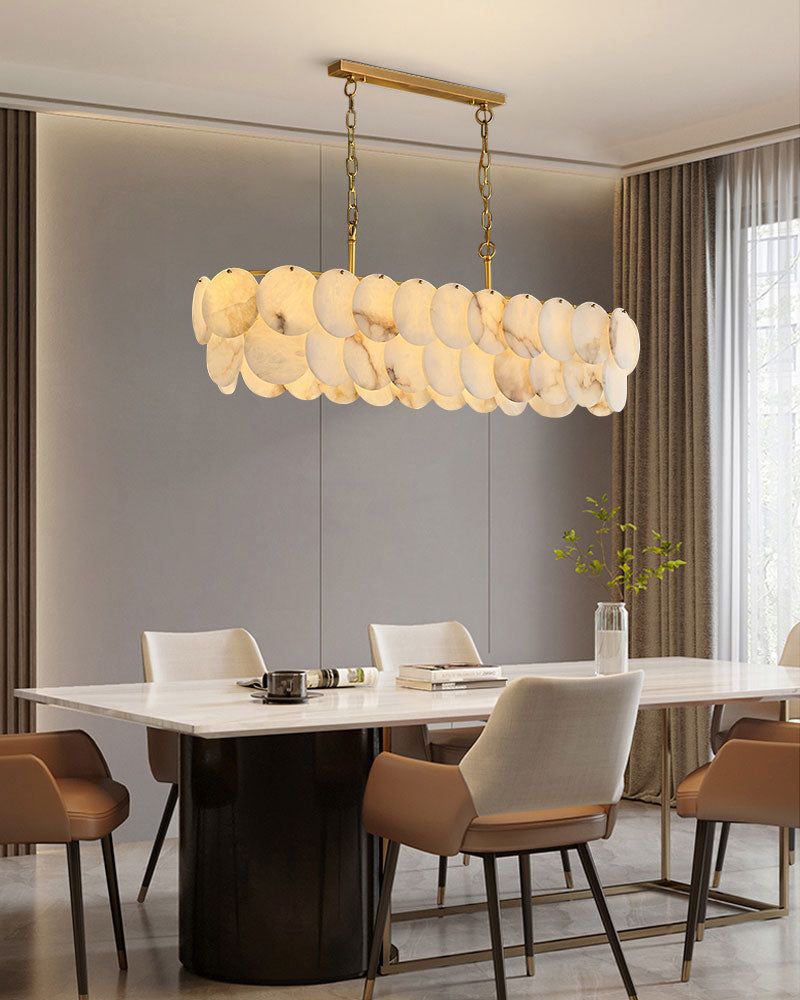 Long linear LED chandelier with Spanish marble shells above a modern dining table
