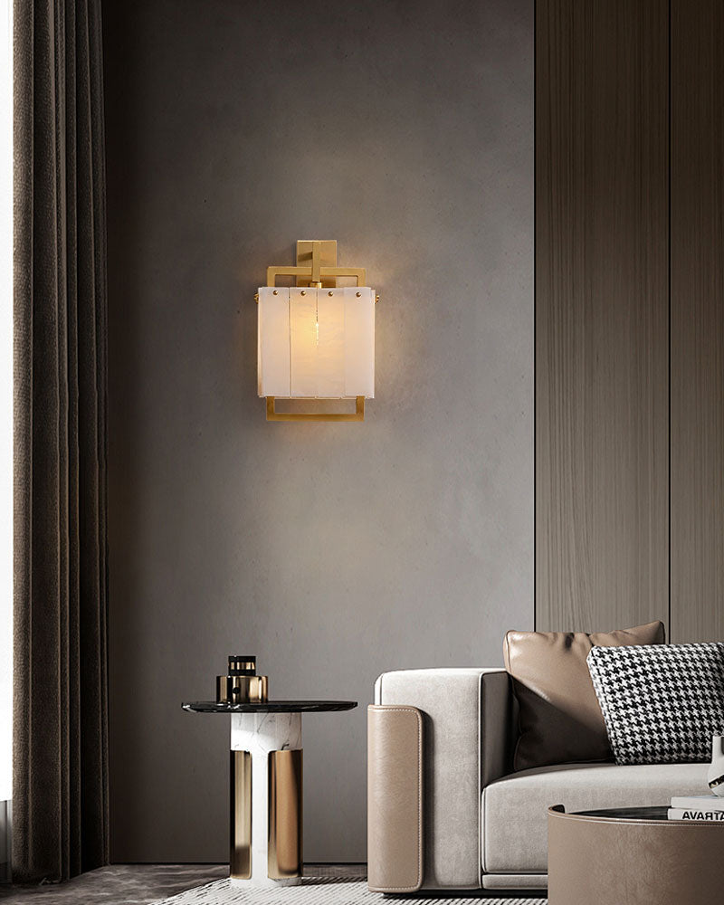 Contemporary living room with brass and alabaster wall light above elegant sofa
