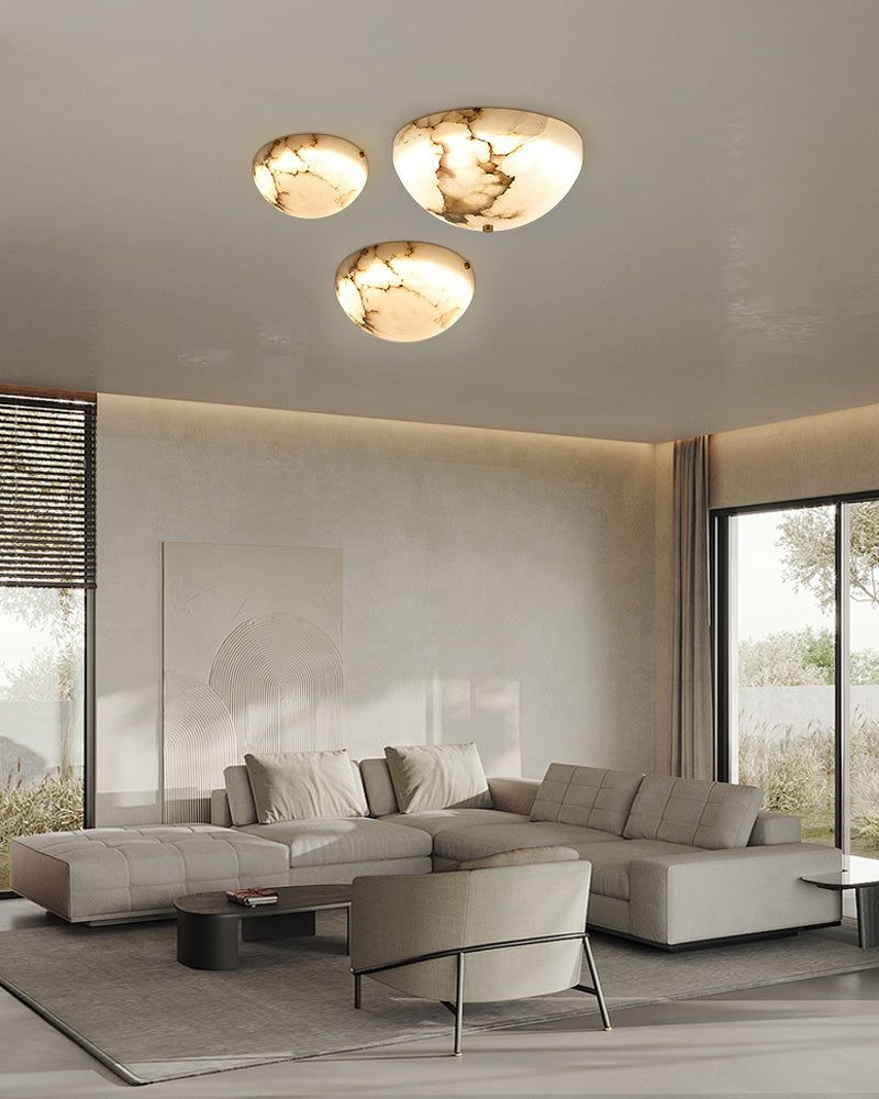 Contemporary living room with three round alabaster ceiling lights and sleek furniture