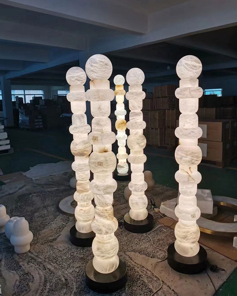 High-standing alabaster floor lamps with geometric design illuminating a modern space