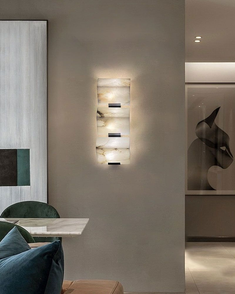 LED alabaster wall sconce in sloping design illuminating modern living space