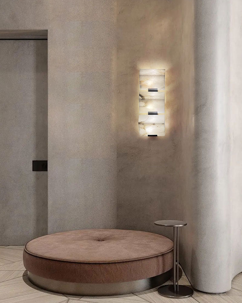 LED alabaster wall sconce on smooth wall illuminating modern seating area